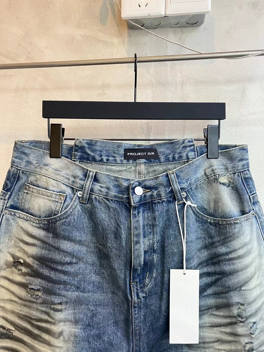 Blue denim shorts front view, button closure, drawstring, large front pockets
