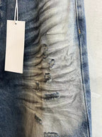Blue denim fabric with ruched wash texture and visible stitch detail