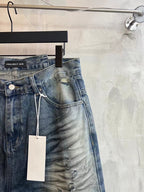 Blue denim shorts side view with frayed hem, drawstring detail and hanging tag