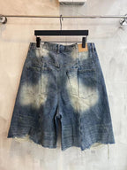 Dark blue denim shorts with paneled waistband, front pockets, frayed hem