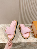 Louis Vuitton pink fabric slide sandals shown side view, with tan sole and gold buckle