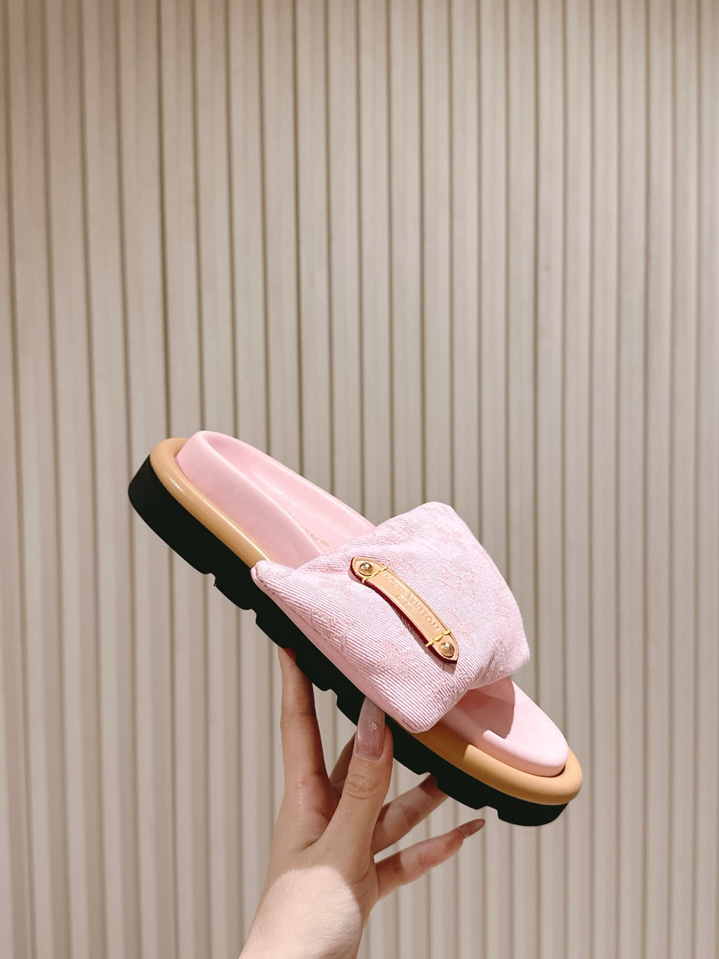 Louis Vuitton pink fabric slide sandals held up, tan footbed and black tread sole