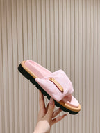 Louis Vuitton pink fabric slide sandals held up, tan footbed and black tread sole