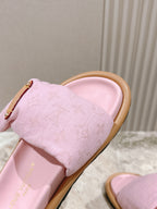 Louis Vuitton pink fabric slide sandal close-up on strap, gold-tone metal buckle