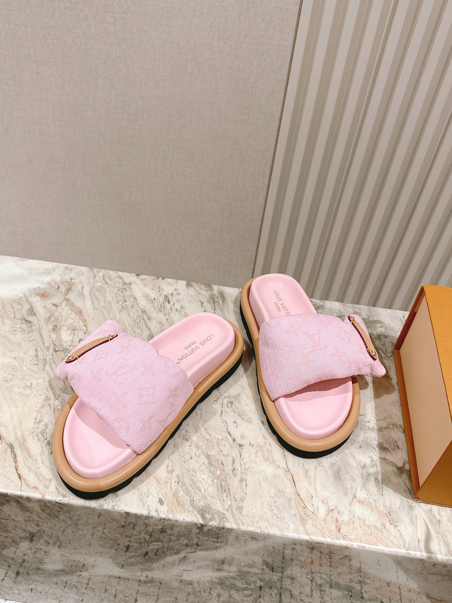 Louis Vuitton pink slide sandals with tan rubber sole and gold-tone strap detail
