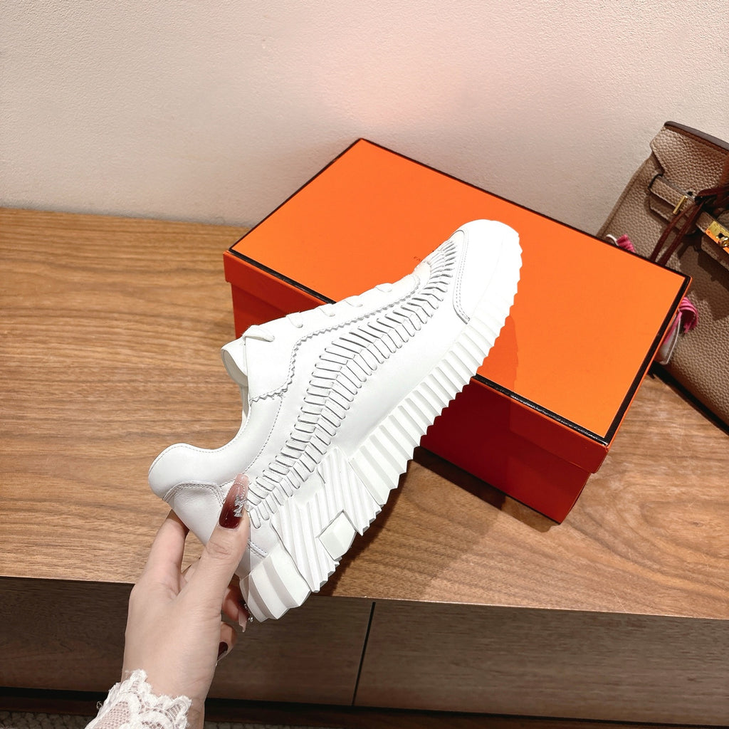Hermes unisex white sneaker sole view, thick tread and cushioned upper