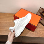Hermes unisex white sneaker sole view, thick tread and cushioned upper