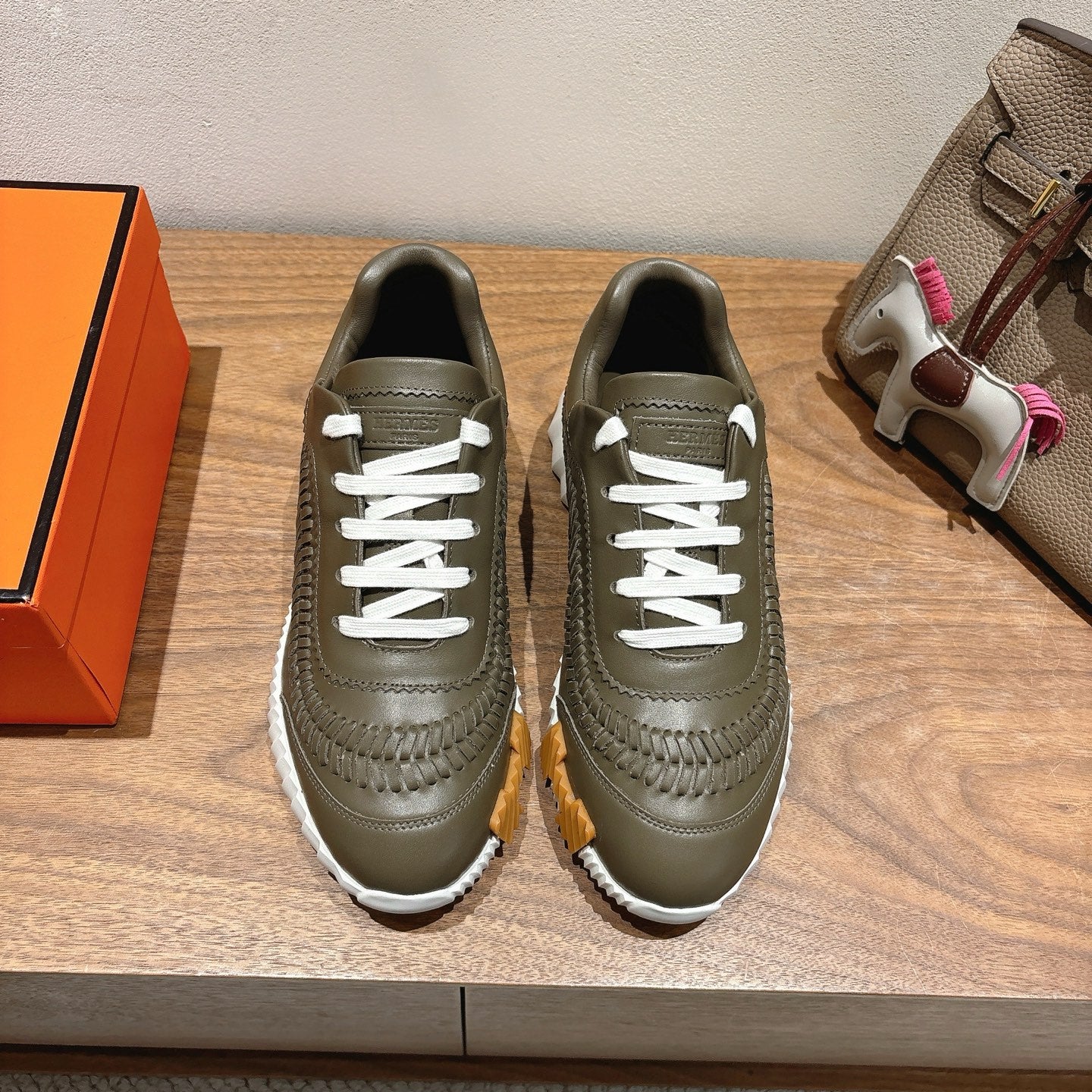 Hermes unisex luxury shoes in olive green with white laces and textured low profile sole