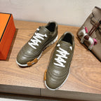 Hermes unisex luxury sneakers in olive green with white laces and chunky sole