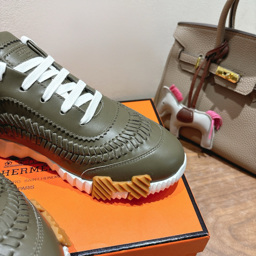 Hermes unisex luxury sneaker in olive green with white laces and embossed leather detailing