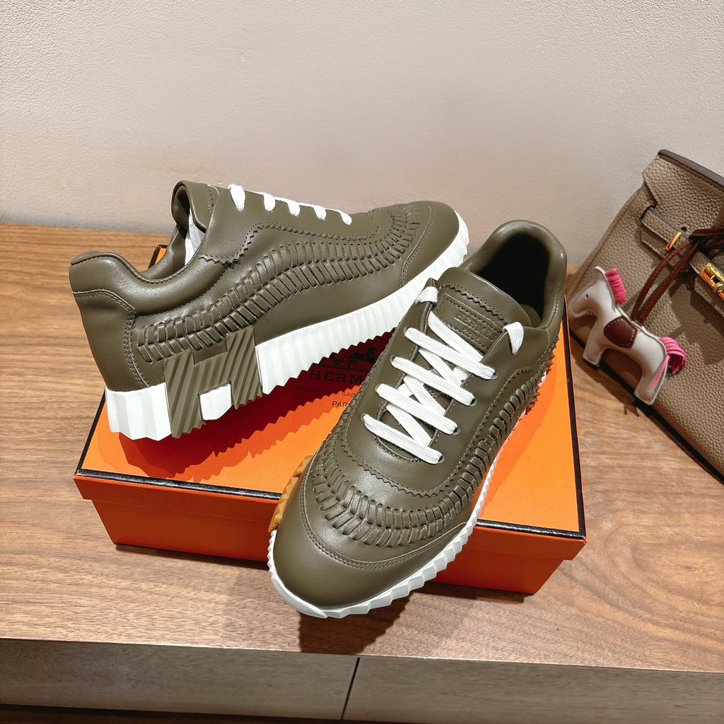 Hermes unisex luxury sneakers in olive green with white laces and thick white ridged sole