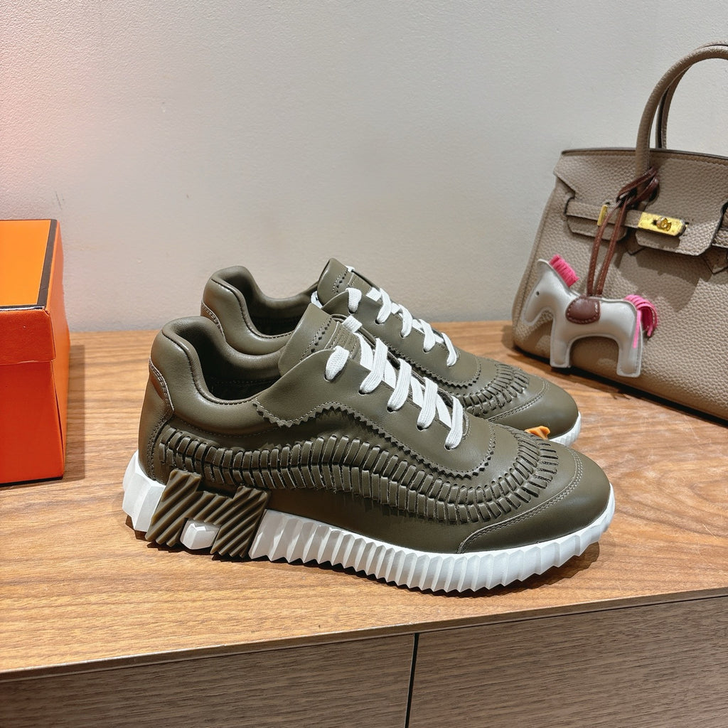 Hermes unisex luxury sneakers in olive green with white laces and stacked ridged sole