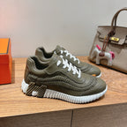 Hermes unisex luxury sneakers in olive green with white laces and stacked ridged sole