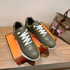 Hermes unisex luxury sneakers in olive green with white laces and ridged white outsole
