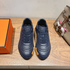 Hermes unisex sneakers in dark blue leather with lace-up front and textured sole