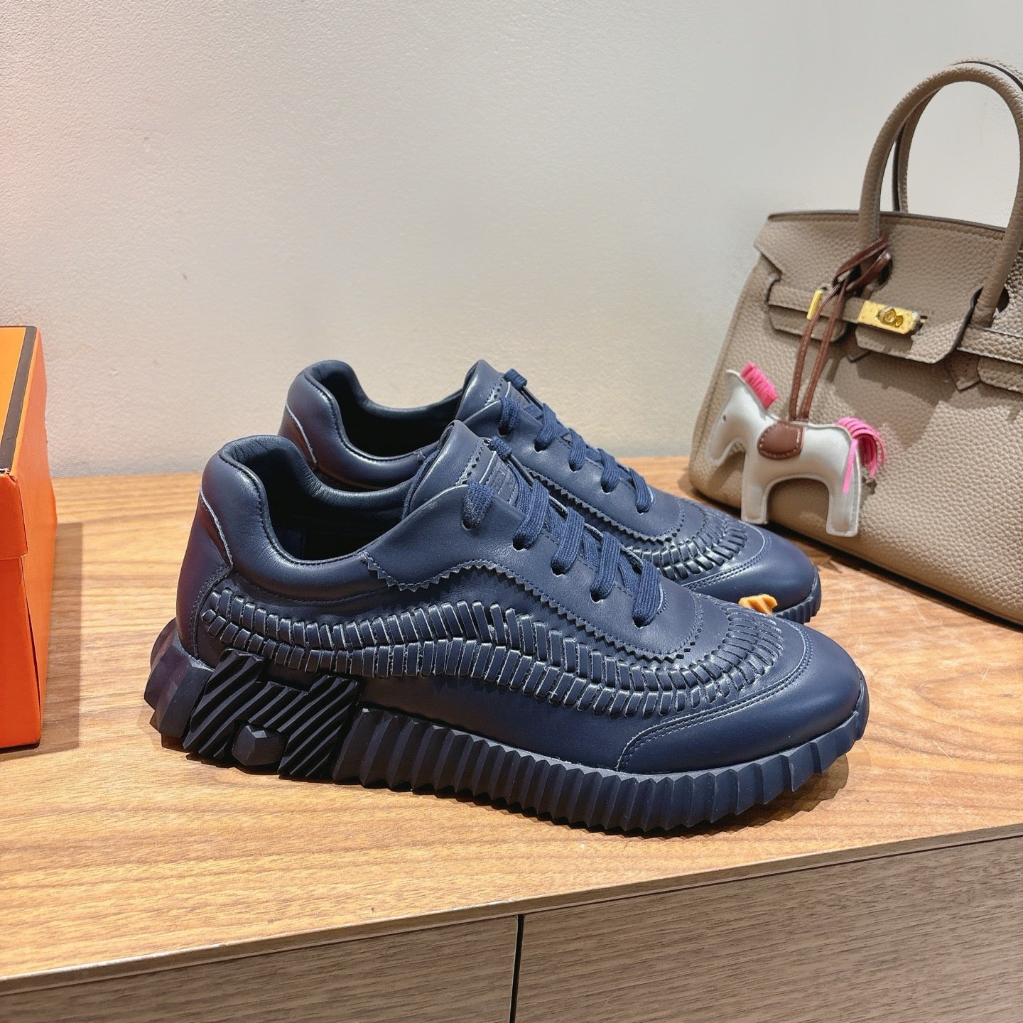 Hermes unisex navy blue lace-up sneakers with embossed detail and chunky sole