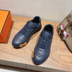 Hermes unisex dark blue lace-up sneakers with textured panels and ridged outsole
