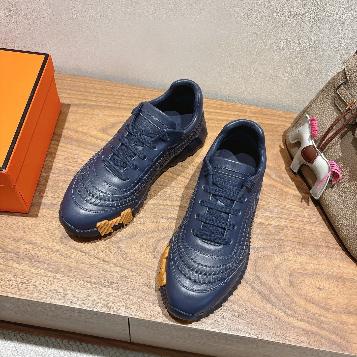 Hermes unisex dark blue lace-up sneakers with textured panels and ridged outsole