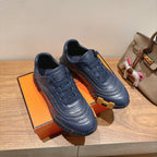 Hermes unisex dark blue lace-up sneakers with textured toe and chunky ribbed sole