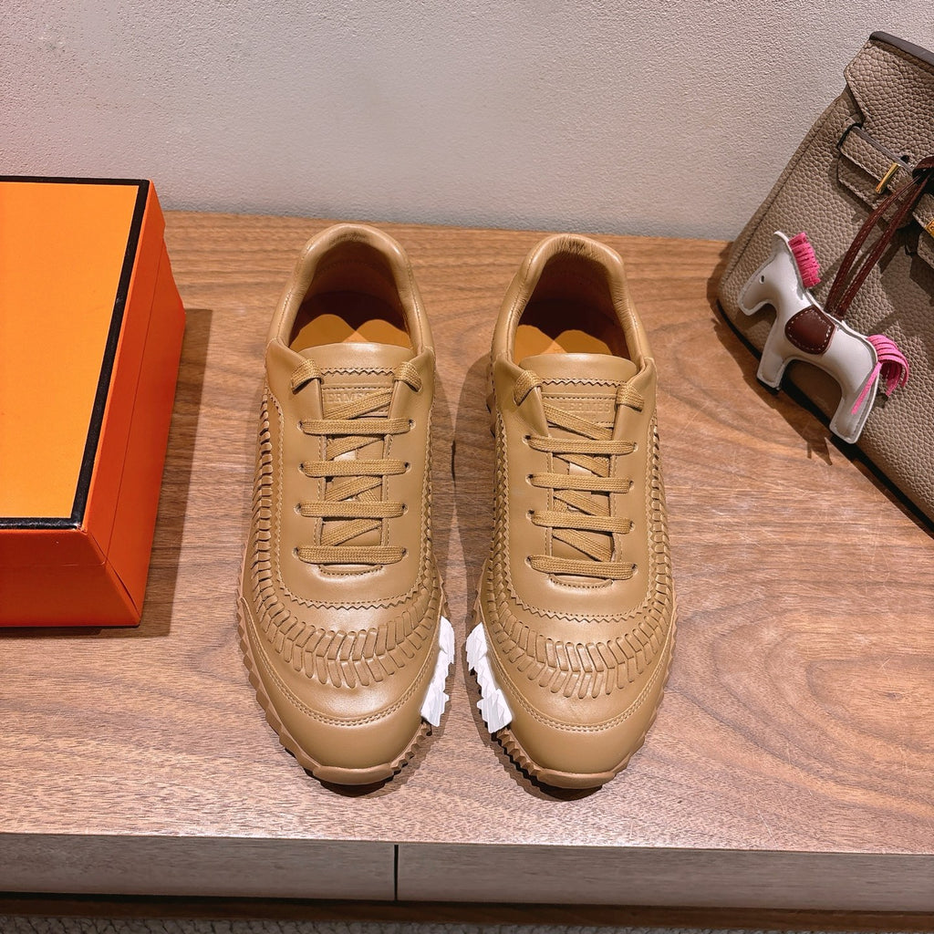 Beige leather lace-up sneakers with ridged sole and decorative side stitching
