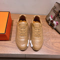 Beige leather lace-up sneakers with ridged sole and decorative side stitching