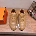 Beige leather lace-up sneakers with ridged sole and decorative side stitching