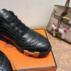 Black lace-up sneaker close-up with textured toe and embossed detailing, Hermes unisex