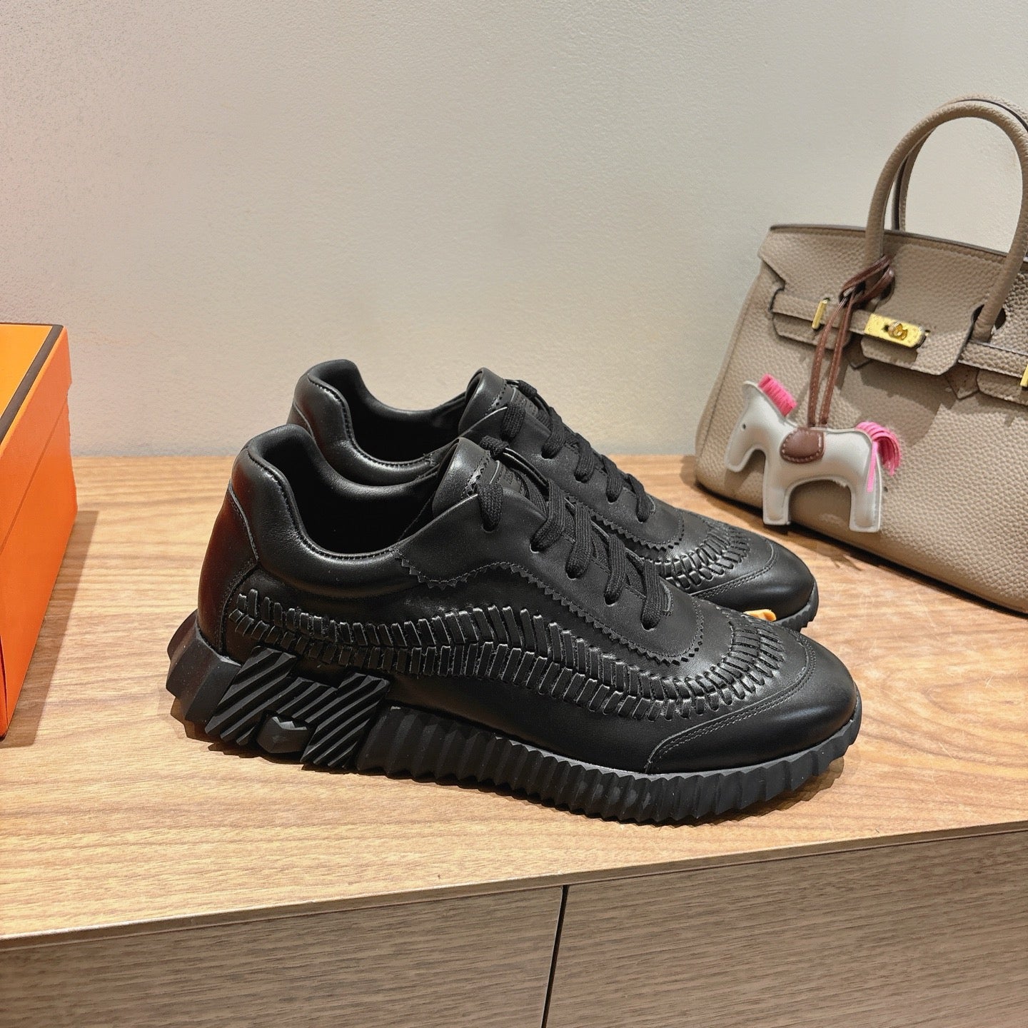 Black chunky lace-up sneaker with textured stripe detailing, Hermes unisex