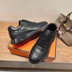 Black sneaker close-up with lace panel and ribbed midsole, Hermes unisex