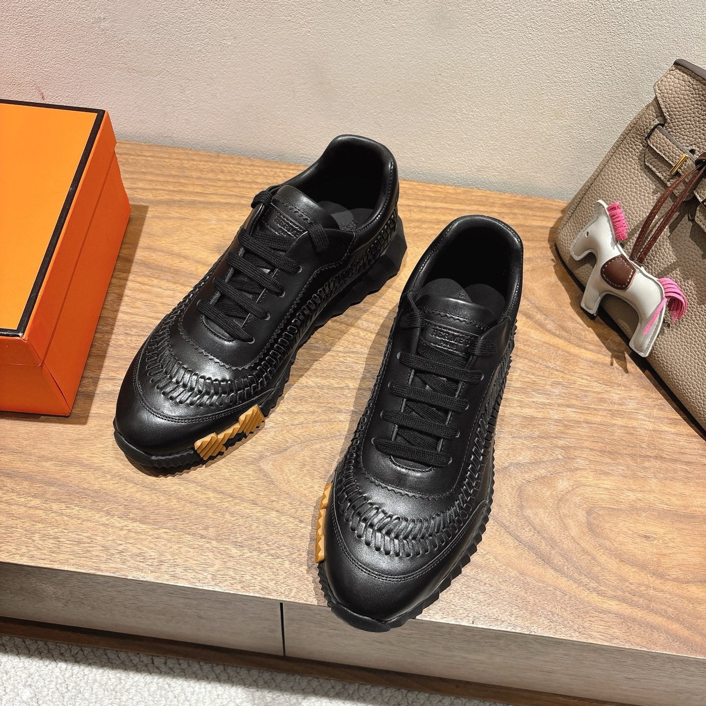 Black lace-up sneakers with side stitching and sculpted sole, Hermes unisex style