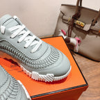 Hermes unisex light blue sneaker with white laces and sculpted patterned midsole