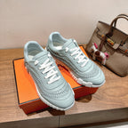 Hermes unisex light blue sneakers with white laces and chunky white tread sole