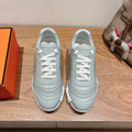 Hermes unisex light blue sneakers with white laces and ribbed side stitching