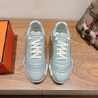 Hermes unisex light blue sneakers with white laces and ribbed side stitching