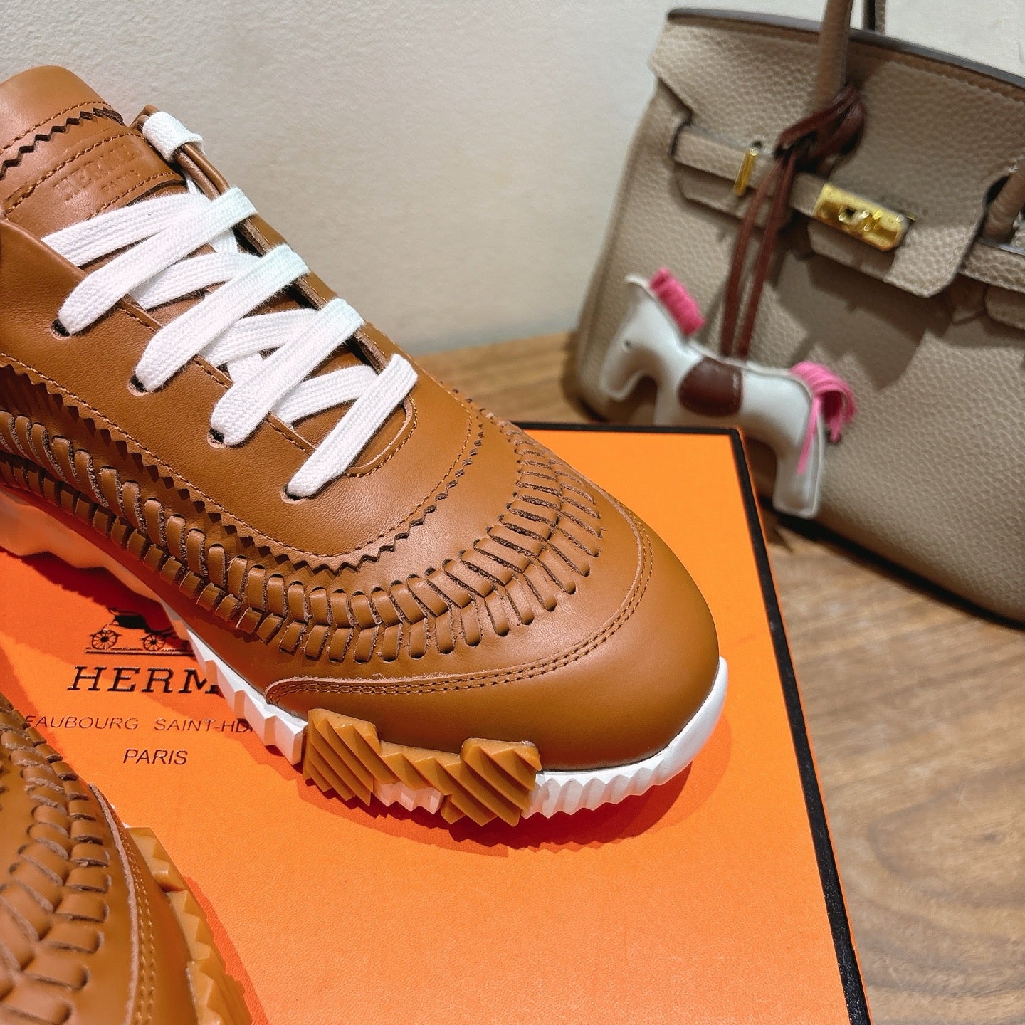 Hermes unisex leather sneaker, tan with white laces and textured braid-like panel detail