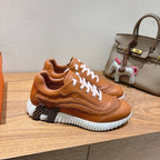 Hermes unisex leather sneakers, tan with white laces and textured stitched detailing