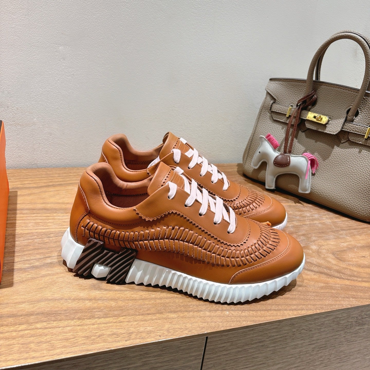 Hermes unisex leather sneakers, tan with white laces and textured stitched detailing