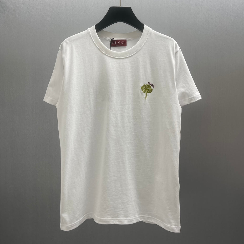 White short-sleeve T-shirt with green rose and small Gucci logo at chest
