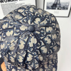 Geometric monogram cap top view with round button and stitched star-like seams