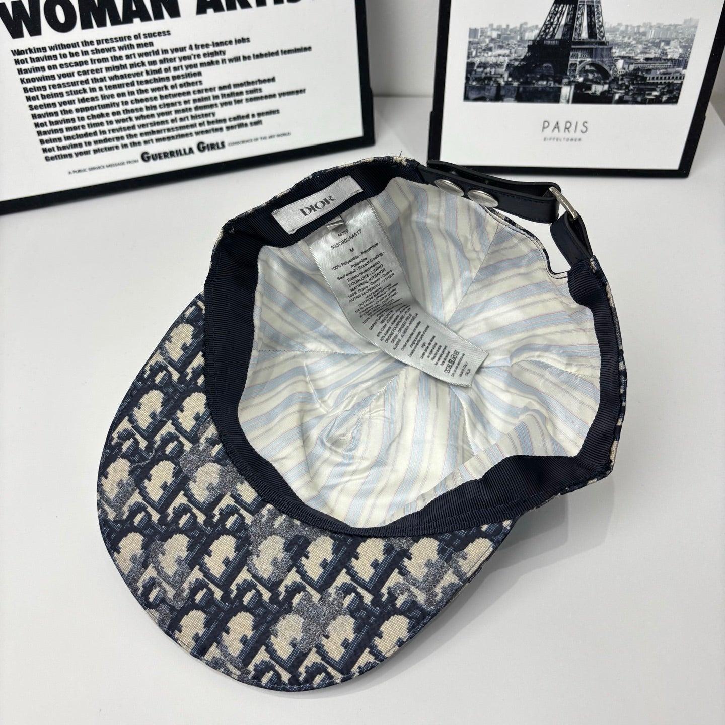 Baseball cap interior with striped lining and care label, adjustable strap