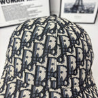 Dior baseball cap close-up with navy-and-cream Dior monogram pattern, curved brim