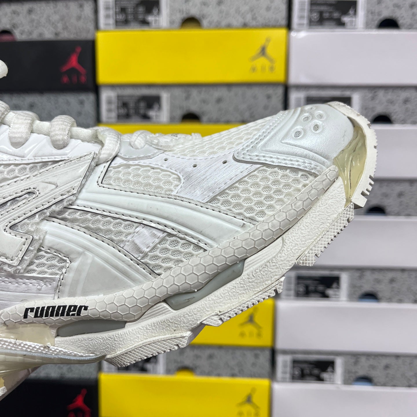 Balenciaga white Runner sneakers, side profile with textured panels and logo