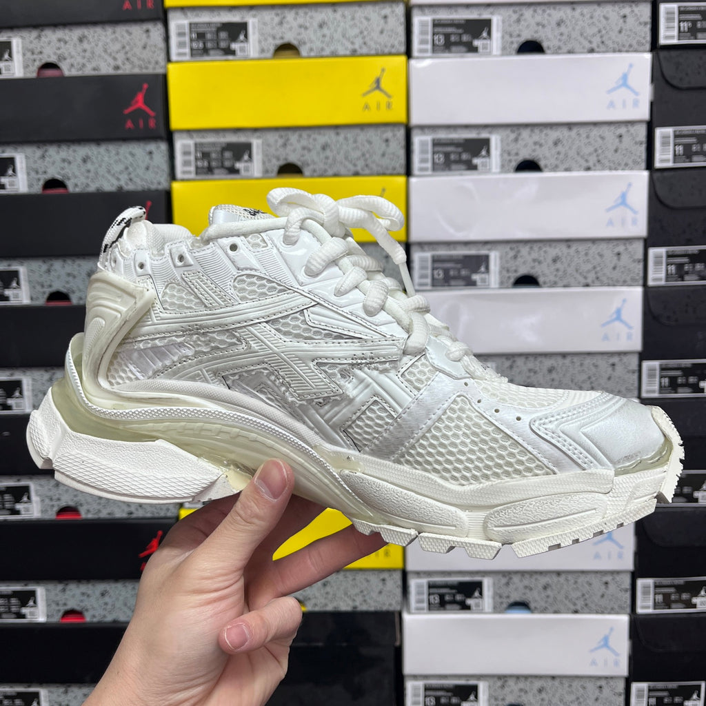 Balenciaga white Runner sneakers, three-quarter front view with lace-up closure