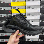 Balenciaga unisex black running sneaker angled side view with lace-up closure