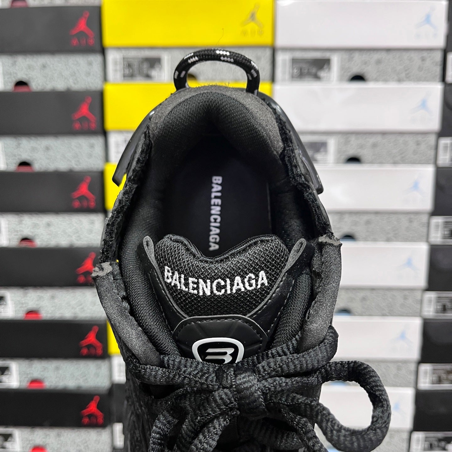 Balenciaga unisex black sneaker heel view with stitched logo and lace tie