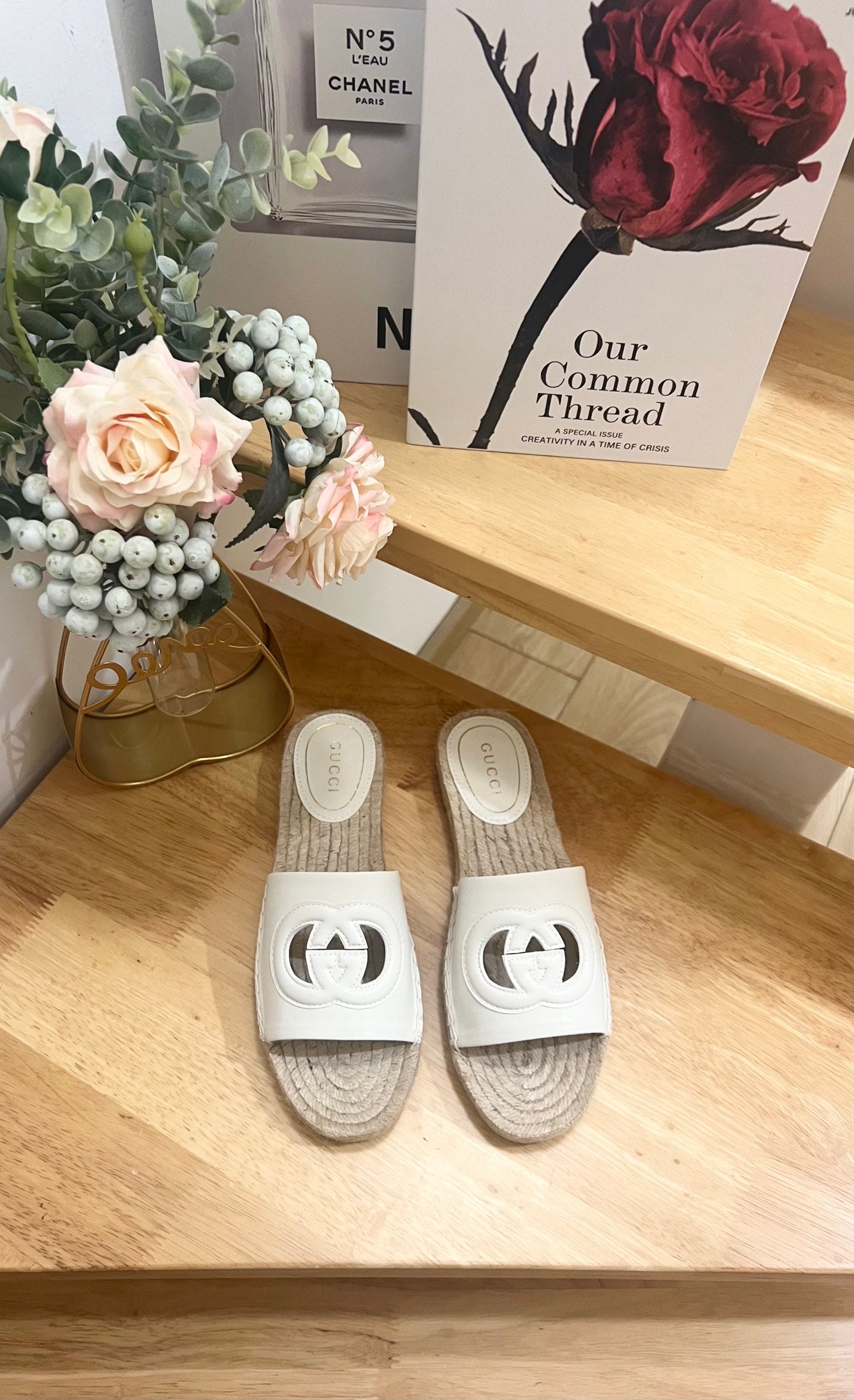 White slide sandals with black logo cutout and jute espadrille sole