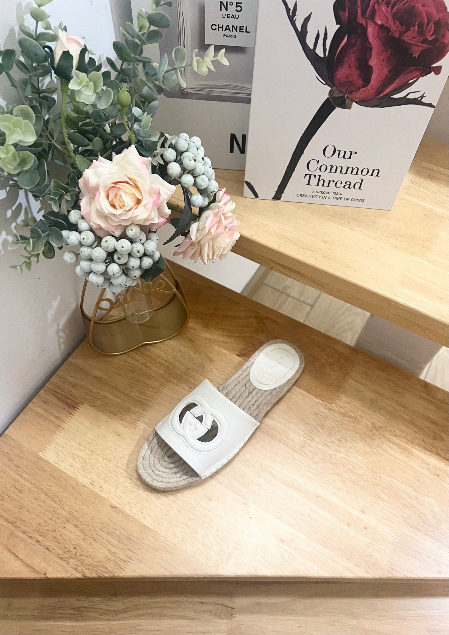 Gucci white slide sandal with logo cutout strap and woven espadrille jute sole.