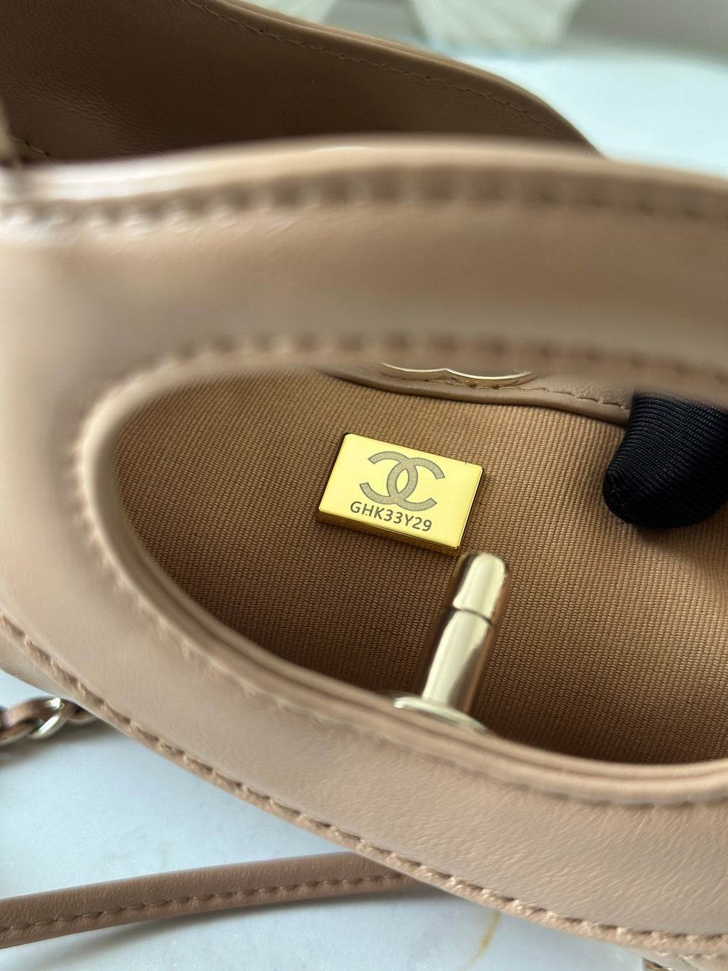 Chanel handbag interior close-up showing fabric lining and size tag