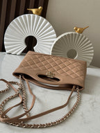 Chanel quilted beige handbag with flap top, gold clasp, and chain shoulder strap