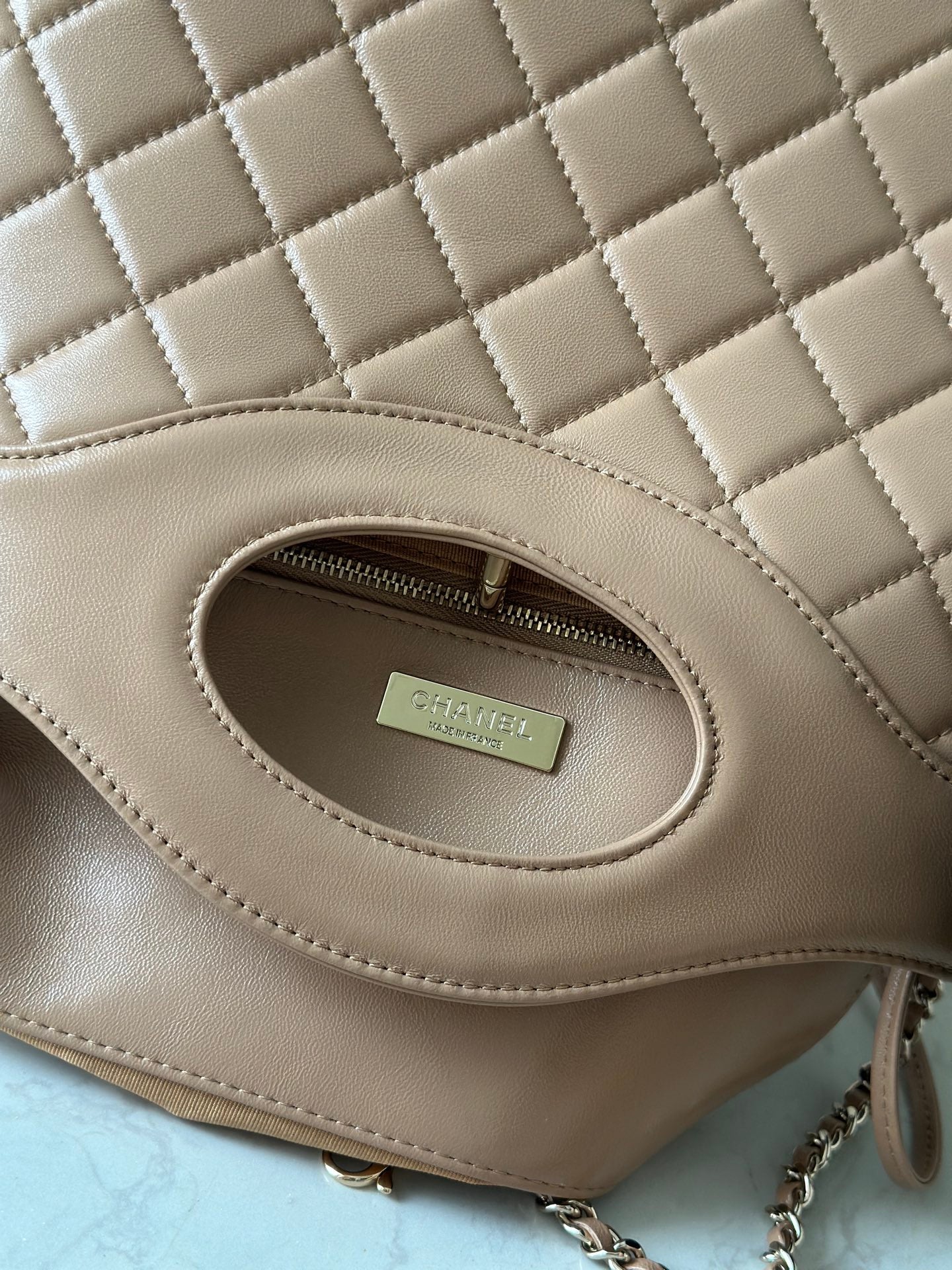 Chanel quilted leather bag interior pocket with zipper and logo label